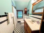 Rinse Away the Beach Day in the Second Bathroom on the Upper Level with a Shower Tub